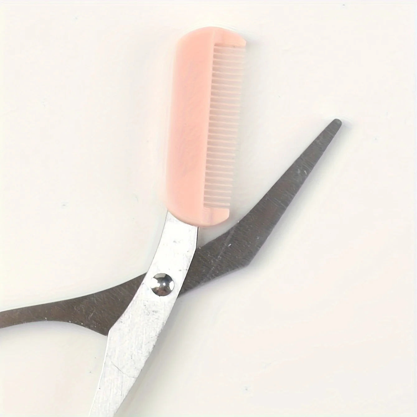 Pink eyebrow trimming scissors with built-in comb - stainless steel, precise grooming tool, creating perfect eyebrows